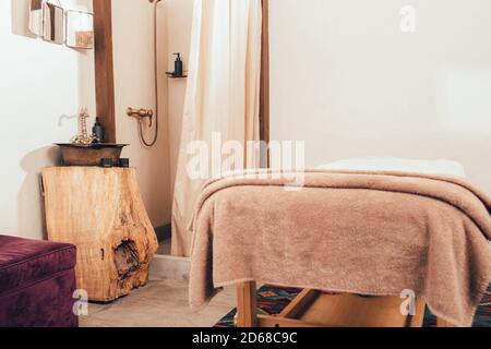 Lavabo, douche et table de massage vintage dans la salle de massage du spa. Détente et soins luxueux Banque D'Images