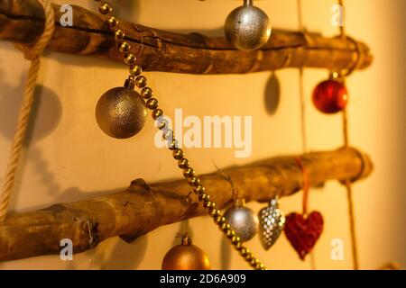 Composition de Noël lumineuse. Guirlande dorée, boules argentées et boules en forme de cœur rouge. Placer pour le texte de message d'accueil Banque D'Images