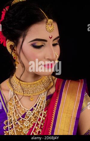 Femme indienne dans Maharashtrian mariée sari et bijoux. Gros plan en regardant vers le bas Banque D'Images