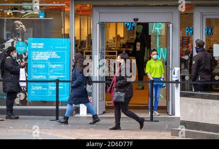 Dundee, Tayside, Écosse, Royaume-Uni. 16 octobre 2020. Météo au Royaume-Uni : couvert et assez froid dans le nord-est de l'Écosse, températures maximales de 10°C. Un membre du personnel de la boutique de mode Primark et un agent de sécurité se tenant devant l'entrée principale de la zone de file d'attente dans le centre-ville de Dundee aujourd'hui pendant les restrictions de confinement de Covid-19. Crédit : Dundee Photographics/Alamy Live News Banque D'Images