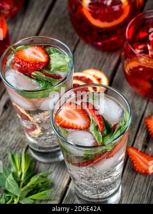 Cocktails à la fraise et à la menthe fraîchement préparés sur une table en bois Banque D'Images