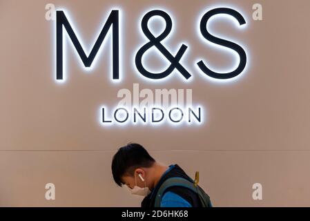 Hong Kong, Chine. 8 octobre 2020. Un masque facial pour piétons passe devant le magasin et le logo de la multinationale britannique Mark & Spencer (M&S) à Hong Kong. Crédit: Budrul Chukrut/SOPA Images/ZUMA Wire/Alay Live News Banque D'Images