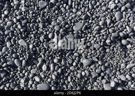 Pierres noires arrondies, cailloux de lave, image de fond, plage Djuponalessandur, Djuponalessandur, Hellnar, péninsule de Snaefellsnes, Snaefellsnes Banque D'Images