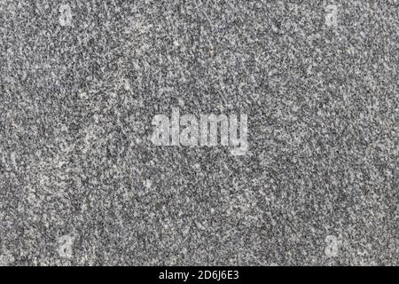 La texture d'une dalle de pierre naturelle en granit poli. Banque D'Images