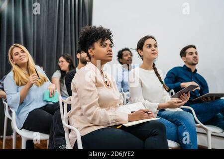 Groupe de personnes d'affaires créatives à l'écoute d'un collègue lors d'une réunion de bureau. Concept d'entreprise et de brainstorming. Banque D'Images