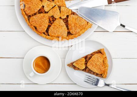 Gros plan tarte aux pommes maison à la cannelle et tasse de café expresso blanc sur table en bois blanc. Vue de dessus. Banque D'Images