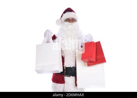 Homme âgé portant un costume traditionnel du Père Noël tenant plusieurs sacs-cadeaux dans les deux mains. Isolé sur blanc. Banque D'Images