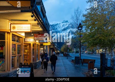 Vue sur la rue de l'avenue Banff en automne et en hiver la nuit durant la période pandémique Covid-19. Banff, Alberta, Canada Banque D'Images