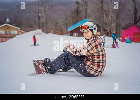 Femme snowboarder sur un jour d'hiver ensoleillé dans une station de ski Banque D'Images