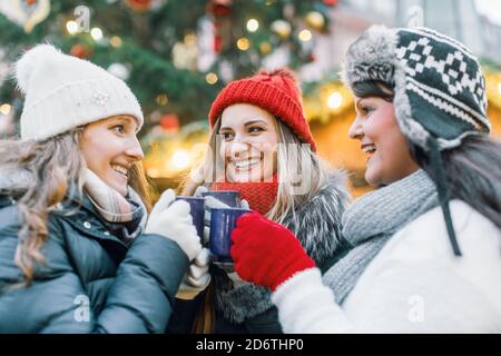 Marché de Noël pour un groupe de femmes amis buvant chaud vin chaud Banque D'Images