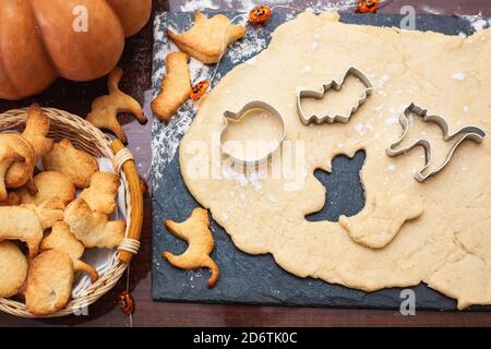 Faire des biscuits pour Halloween. Coupez les biscuits de la pâte sous forme de citrouille, chat, fantôme et chauve-souris. Banque D'Images