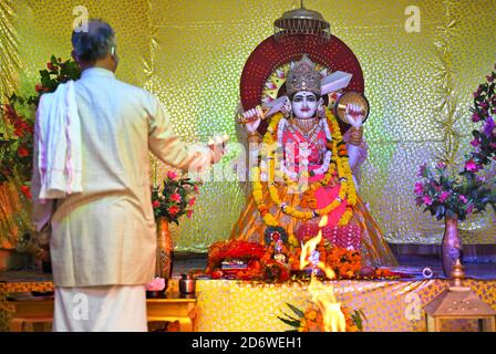 Beawar, Rajasthan, Inde, 19 octobre 2020: Le prêtre hindou interprète 'aarti' de la déesse Durga pendant le festival Navratri en cours dans le cadre de la pandémie du coronavirus, au temple d'Ashamura Mata à Beawar. Sharad Navratri est célébré dans le mois Saint d'Ashwin. Le festival de neuf jours de Durga Puja, qui commémore la chute du roi démon Mahishasur par la déesse Durga, marque le triomphe du bien sur le mal. Les dévotés sont rapides pendant la période et visitent les temples. Crédit : Sumit Saraswat/Alay Live News Banque D'Images