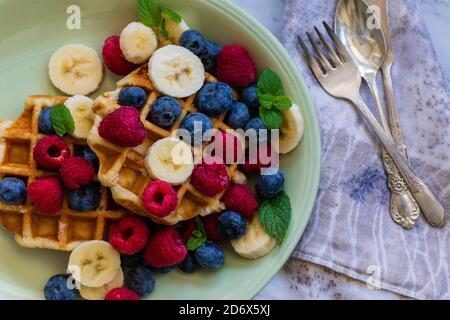 gaufres, bleuets, framboises, bananes et menthe. Banque D'Images