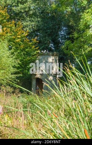 Tour d'eau en pierre qui jaillissent de l'eau d'un gargouille, Westonbury Mill Water Gardens, Herefordshire, Royaume-Uni. Septembre 2020 Banque D'Images