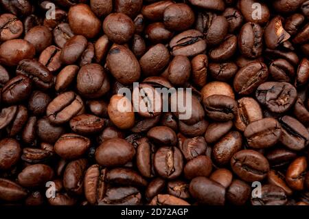 Stimulant énergétique et Java doux concept avec photo plein cadre de grains de café de torréfaction empilés Banque D'Images
