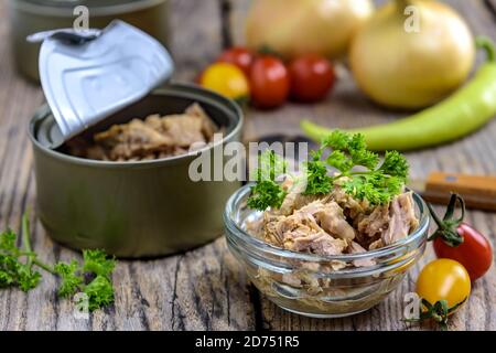 Portion de salade de thon avec persil frais et légumes sur table rustique en bois. Mise au point sélective. Banque D'Images