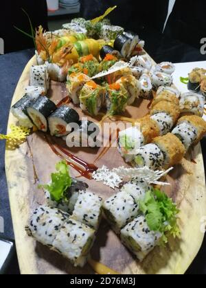 Plan vertical de différents rouleaux de sushi plaqués sur un bois conseil avec une belle présentation Banque D'Images