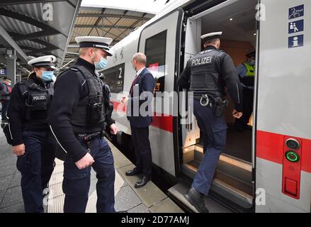 21 octobre 2020, Thuringe, Erfurt: Des policiers fédéraux embarquent dans LA GLACE 602 de Munich à Hambourg pour vérifier le respect des règles d'hygiène, en particulier le port d'un nez et d'une coiffe. Selon la Deutsche Bahn, des mesures de prévention et de contrôle sont régulièrement mises en œuvre dans les trains et les gares de toute l'Allemagne, avec le soutien de la police fédérale. La majorité des passagers se conforment à l'obligation de porter des masques, ce qui s'applique également aux autres moyens de transport en commun, a déclaré la porte-parole de la Deutsche Bahn. Photo: Martin Schutt/dpa-Zentralbild/dpa Banque D'Images