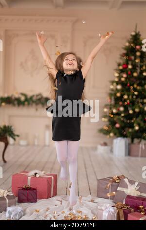 Petites filles jetés confetti. Magie de Noël. Des moments joyeux d'une enfance heureuse. Banque D'Images