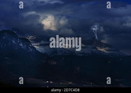 Une scène à couper le souffle de montagnes sous un ciel nuageux la foudre la nuit Banque D'Images
