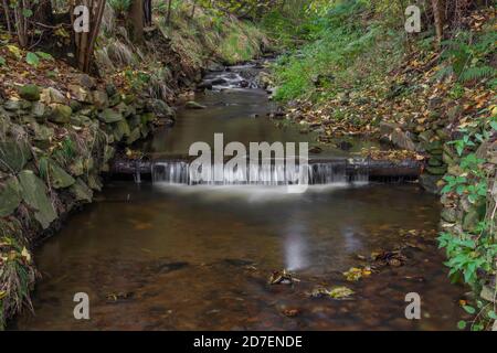 ruisseau Krasetinsky près du confluent avec ruisseau Kremzsky avec petite cascade en automne matin Banque D'Images