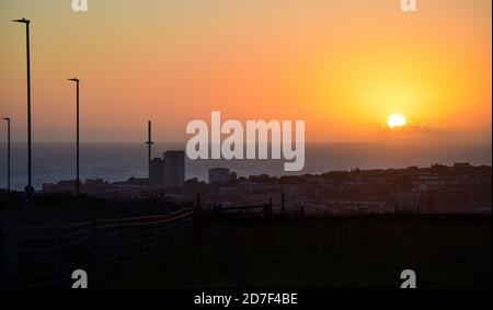 Brighton UK 22 octobre 2020 - le soleil se couche sur Brighton et la tour BA i360 sur le front de mer vue de Tenantry à l'est de la ville, car le temps instable devrait se répandre dans toute la Grande-Bretagne au cours des prochains jours : Credit Simon Dack / Alamy Live News Banque D'Images