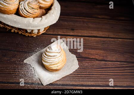 Pâtisseries modernes dans 2020 croûtes, un mélange de croissants et de muffins. Un coffin sur une table sombre arrosé de sucre en poudre. Vue de l'hôtel Banque D'Images