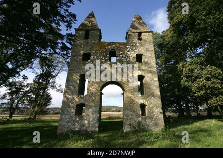 Borders The Hundy Mundy à Mellerstain House nr Kelso. Hundy Mundy Tower, Tour de Melrose, Écosse, Royaume-Uni. Une folie nommée d'après une princesse qui domine les corps dans un site naturel de sépulture des bois.Une folie gothique construite pour compléter la vue conçue qui s'étend au sud-est de Mellerstain dans les frontières écossaises, Hundy Mundy occupe un emplacement spectaculaire à 1,5 km (5 miles) au nord-est de Smailholm et à 8 km (miles) nord-ouest de Kelso. Commencé en 1726 et comprenant une grande arche entre des tours carrées, qui sont couvertes par des pyramides, c'était l'oeuvre de William Adam (1689 - 1748) qui avait été l'architecte Banque D'Images