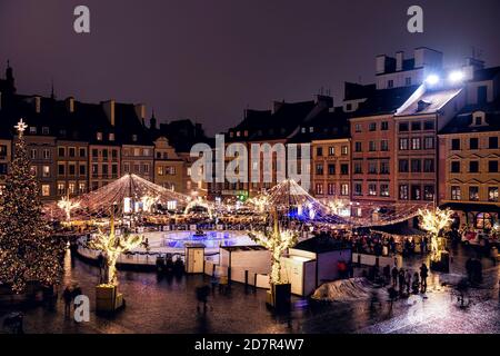 Varsovie, Pologne - 22 décembre 2019 : place du marché de la vieille ville de Varsovie la nuit avec décoration illuminée de Noël et arbre du nouvel an avec skat Banque D'Images