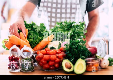 Homme adulte méconnaissable avec beaucoup de légumes sur la table - repas de saison de couleur et fruits pour végétarien ou les gens vegan - vie saine Banque D'Images