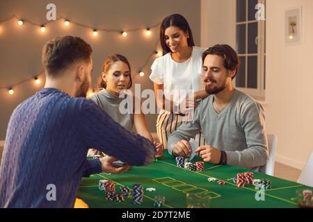 Groupe de jeunes amis en attente de carte du pont pendant paris et jouer au poker Banque D'Images