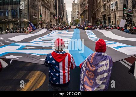 Porteur d'un drapeau « Loi et ordre » surdimensionné, les partisans de Trump défilés de la Trump Tower à Times Square à New York le 25 octobre 2020. (Photo de Gabriele Holtermann/Sipa USA) crédit: SIPA USA/Alay Live News Banque D'Images