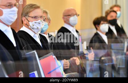 26 octobre 2020, Thuringe, Weimar: Les juges de la Cour constitutionnelle de Thuringe se tiennent côte à côte dans la salle d'audience au début de la procédure, avec la bouche et le nez couverts. La Cour constitutionnelle de l'État est en voie d'entendre une plainte de l'AfD de Thuringe contre la commission des conditions difficiles de l'État. Selon le ministère des migrations, la commission peut accorder des permis de séjour aux réfugiés et autres étrangers qui auraient à quitter le pays sur décision des autorités. Les raisons humanitaires ou personnelles ont joué un rôle dans les décisions. Une décision est attendue dans de Banque D'Images