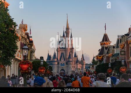 Des foules de touristes descendent main Street, Magic Kingdom, Disney World vers le château de Cenderalla au lever du soleil décoré pour Halloween Banque D'Images