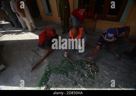 Peshawar, Pakistan. 27 octobre 2020. Des agents de secours pakistanais et des policiers examinent le site d'une explosion de bombe dans un séminaire islamique. Mardi matin, une puissante explosion de bombes a déchiré le séminaire islamique en périphérie de la ville de Peshawar, dans le nord-ouest du Pakistan, tuant quelques étudiants et blessant des dizaines d'autres personnes, ont déclaré la police et un porte-parole de l'hôpital. (Photo de Hussain Ali/Pacific Press) crédit: Pacific Press Media production Corp./Alay Live News Banque D'Images