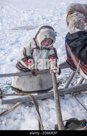 Une jeune fille de Nenet en tenue traditionnelle jouant avec un