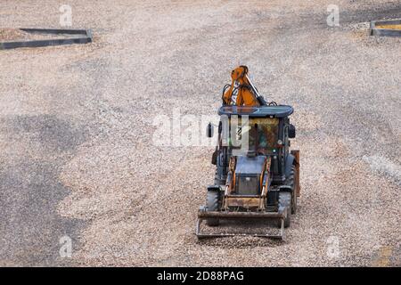 Russie, Kaluga - 27 OCTOBRE 2020 : tracteur avec godet de nivellement de gravier pour la construction de routes. Banque D'Images