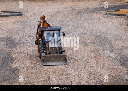 Russie, Kaluga - 27 OCTOBRE 2020 : tracteur avec godet de nivellement de gravier pour la construction de routes. Banque D'Images