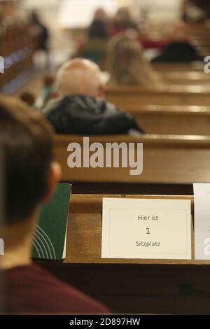 26 octobre 2020, Saxe-Anhalt, Wernigerode: Les visiteurs s'assoient lors d'un événement dans l'église Saint-Sylvestri à Wernigerode. Selon les règles de distance, les sièges sont signalés par un avis. Il existe des exigences en matière de protection contre les infections, telles que les règles de distance, les masques obligatoires et les listes de contacts. Dans de nombreux endroits, la musique d'église est limitée à la musique d'orgue. Photo: Matthias Bein/dpa-Zentralbild/ZB Banque D'Images