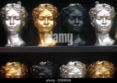 Femme buste Sculpture dans différentes couleurs. Isolé sur un noir. Plâtre sculpture visage de femme. Banque D'Images