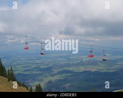 Télésiège dans les alpes bavaroises en période de changement climatique Et Covid-19 avec chaises rouges vides Banque D'Images
