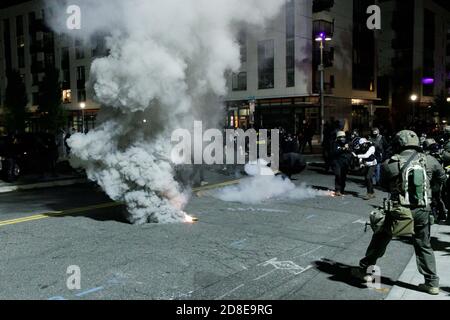 La police fédérale lance des flashbangs et larme des grenades à gaz sur les manifestants. Des manifestants se sont affrontés avec la police fédérale au cours du cinquième mois de manifestations, après que les manifestants se soient approchés d'un bâtiment DE GLACE (Immigration et police des douanes) dans le centre-ville de Portland, Oregon, le 28 octobre 2020. (Photo de John Rudoff/Sipa USA) crédit: SIPA USA/Alay Live News Banque D'Images