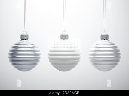 Composition en noir et blanc de trois boules de Noël à côtes horizontales accrochées sur fond blanc. Décoration de Noël, atmosphère festive Banque D'Images