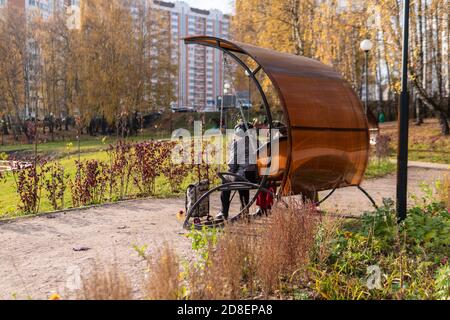 L'urne dans le parc, une poubelle en métal dans l'herbe verte dans la nature ouverte près de la route des pierres, dans l'après-midi par temps ensoleillé profiter du concept Banque D'Images