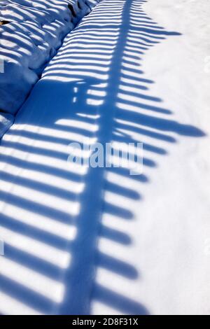 La clôture de piquetage projette des ombres et des motifs sur la neige fraîche; Salida; Colorado; États-Unis Banque D'Images