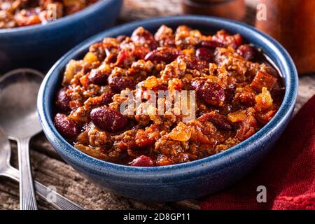 Un bol de délicieux Chili chaud épicé con carne avec du bœuf haché, de l'oignon, de la tomate et des haricots rouges. Banque D'Images