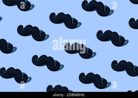 Motif de moustache noir sur fond bleu. Lumière dure. Composition du concept de sensibilisation au cancer de la prostate. Banque D'Images