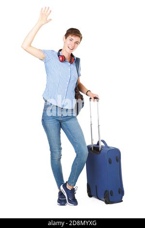 Portrait complet de la jeune femme heureuse avec sacs de voyage la main se coucou Banque D'Images