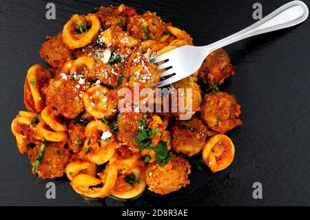 Boulettes de viande de bœuf et de porc Al Forno avec pâtes de trulli repas de sauce tomate sur fond de pierre d'ardoise Banque D'Images