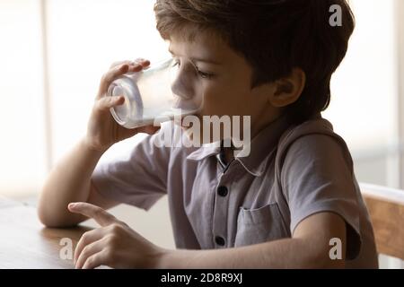 Petit garçon enfant boire du lait biologique sain à partir du verre Banque D'Images